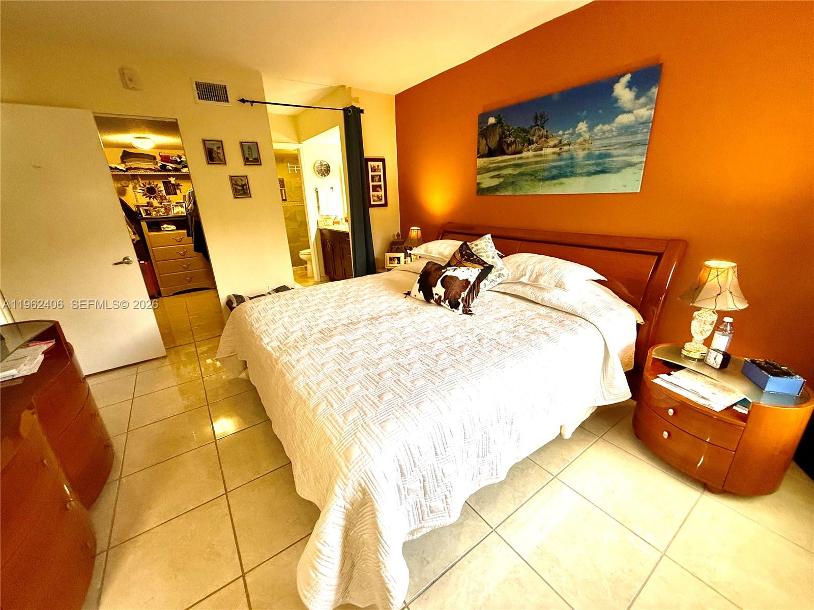 351 Club Circle, Unit 102 Boca Raton, FL 33487 - Photo 22 of 34 a bedroom with a bed and a walk in closet