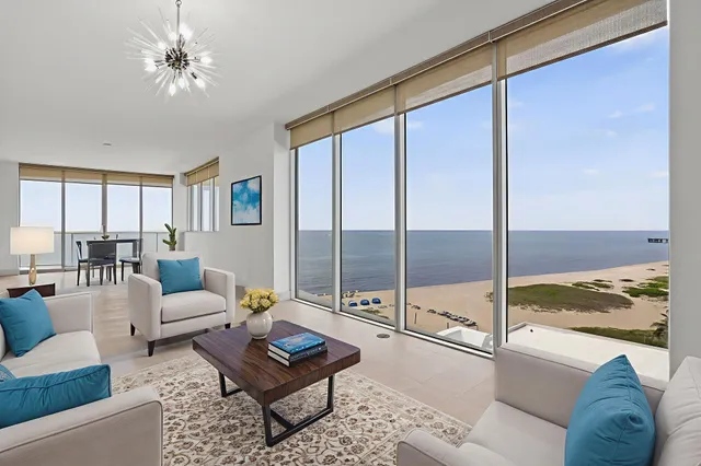 a dining hall with stainless steel appliances kitchen island granite countertop a dining table chairs and granite counter tops