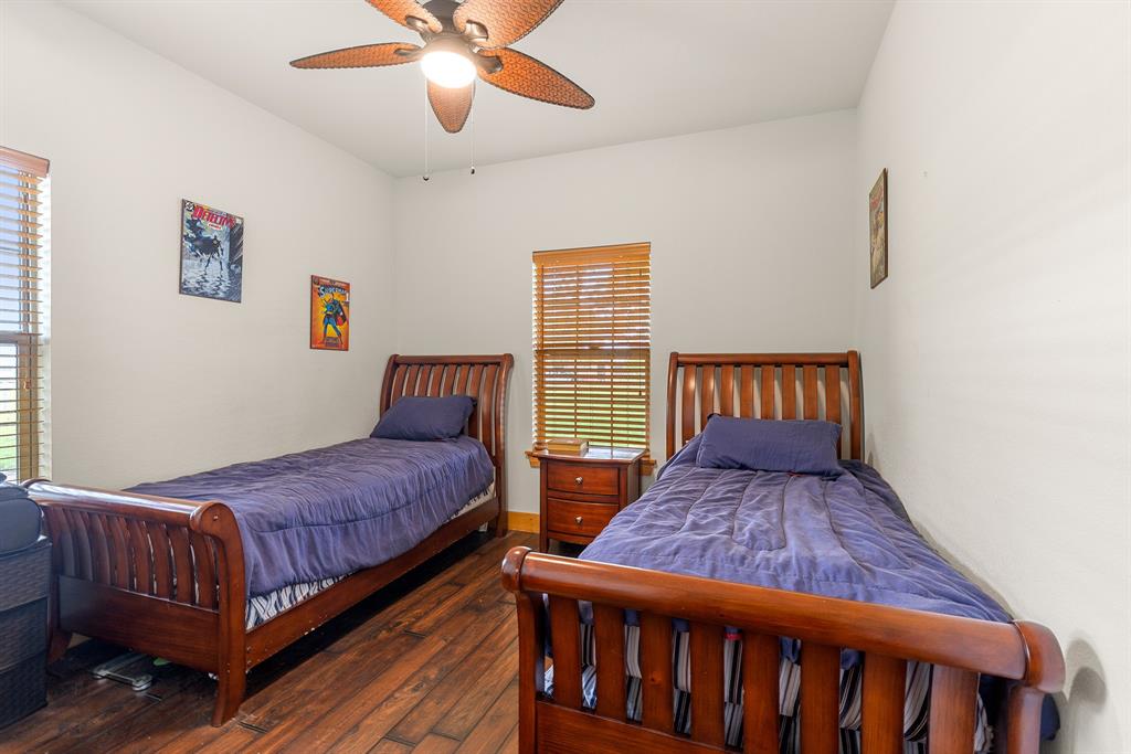 789 Stiles Road, Unit 789 Whitesboro, TX 76273 - Photo 11 of 34 Bedroom with dark wood-style flooring and a ceiling fan