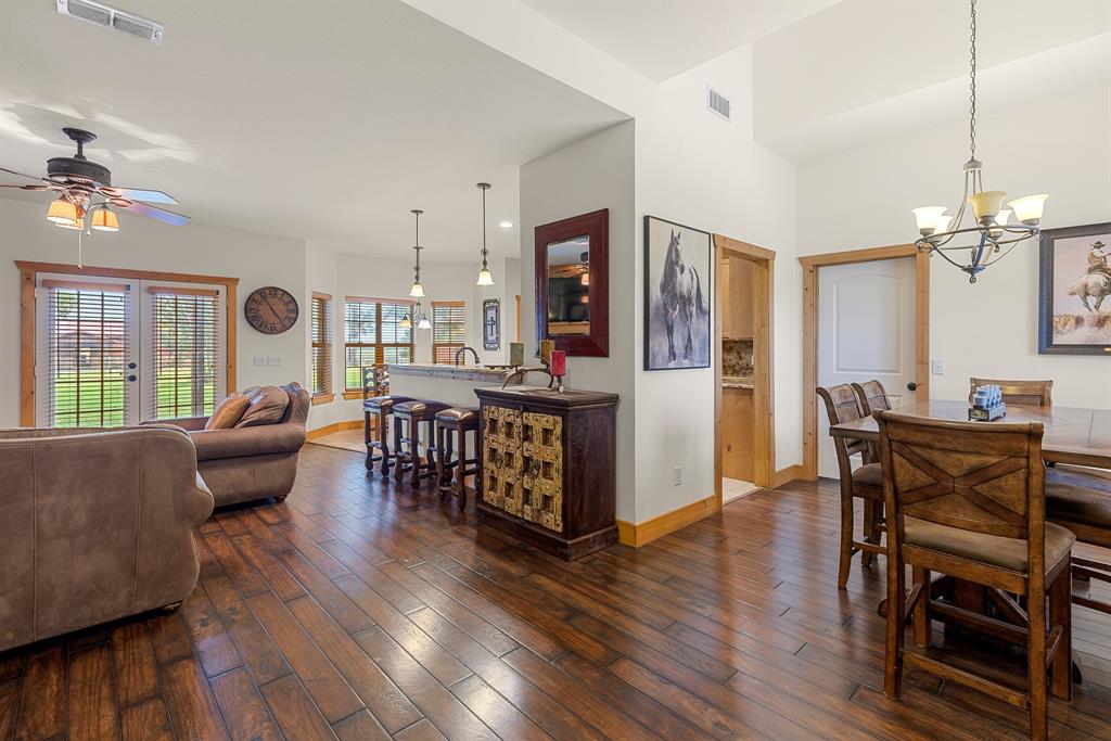 789 Stiles Road, Unit 789 Whitesboro, TX 76273 - Photo 14 of 34 Dining room featuring dark wood finished floors, a chandelier, and ceiling fan