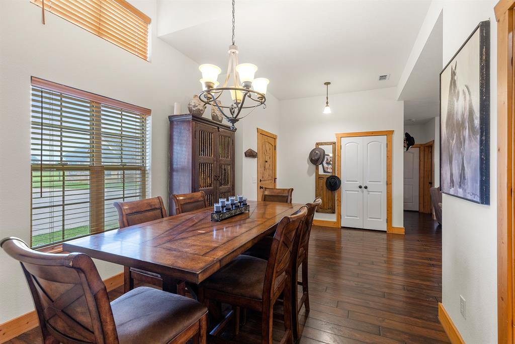 789 Stiles Road, Unit 789 Whitesboro, TX 76273 - Photo 18 of 34 Dining room featuring dark wood finished floors and a chandelier