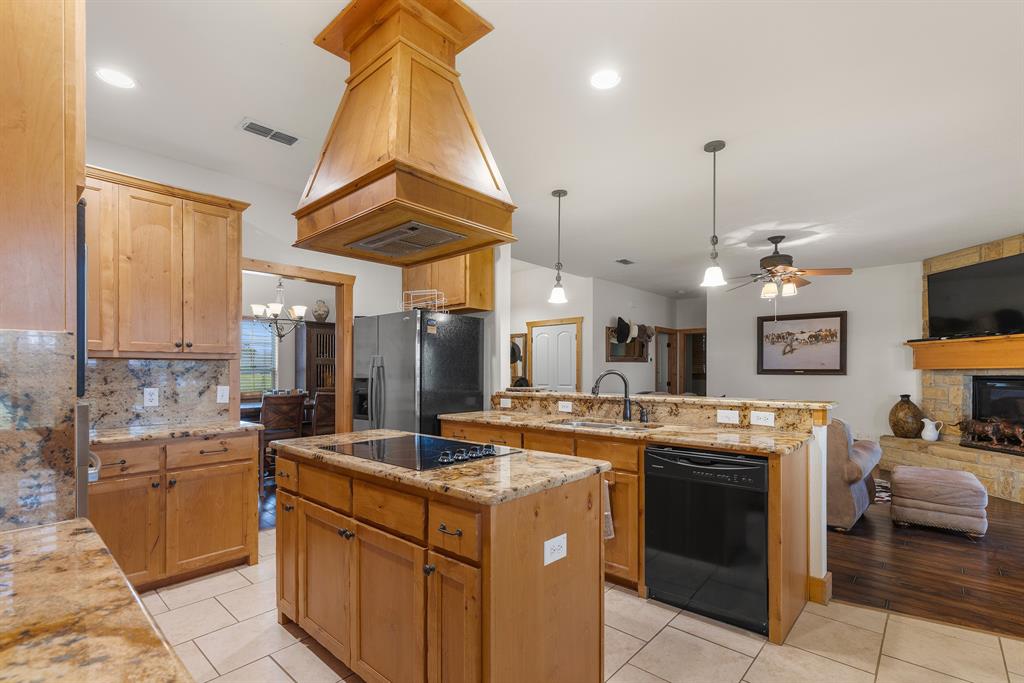 789 Stiles Road, Unit 789 Whitesboro, TX 76273 - Photo 34 of 34 Kitchen with open floor plan, decorative backsplash, pendant lighting, and a kitchen island