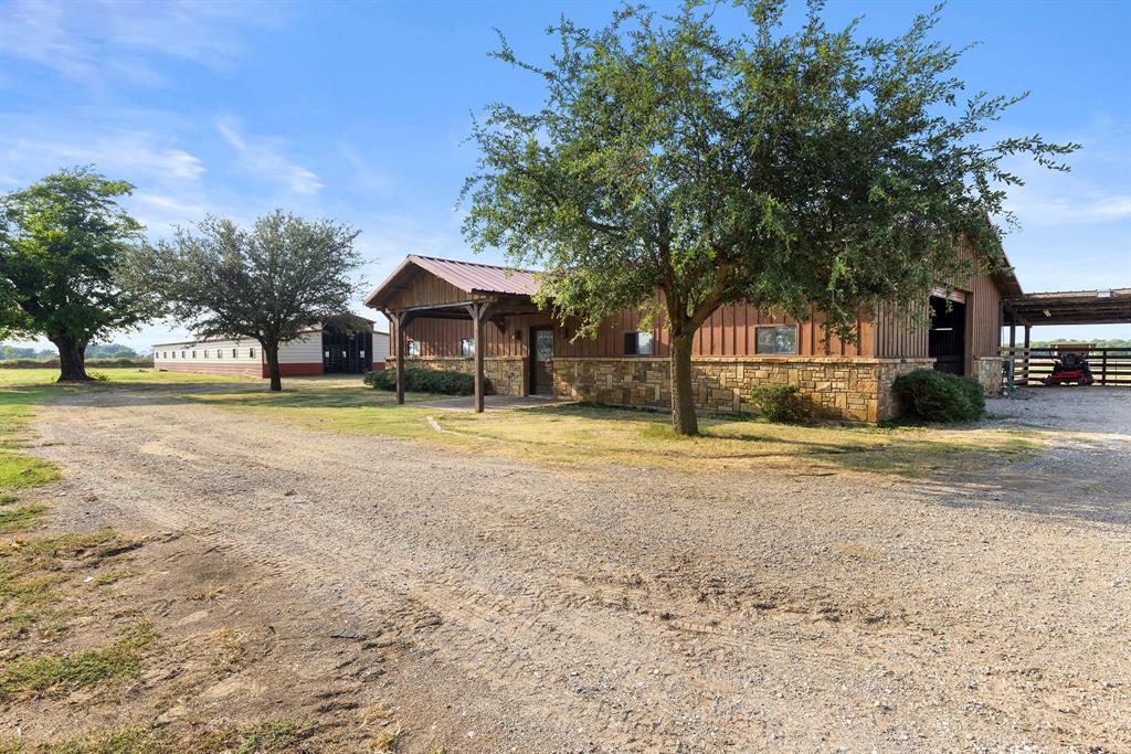 789 Stiles Road, Unit 789 Whitesboro, TX 76273 - Photo 27 of 34 View of front of property featuring stone siding, board and batten siding, and dirt driveway