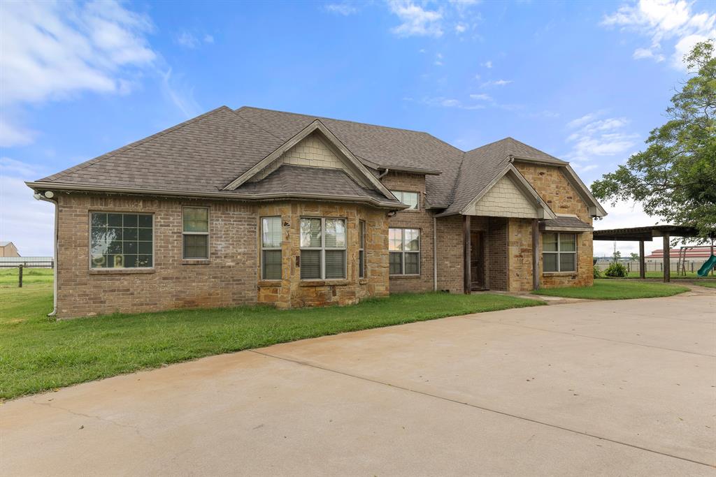 789 Stiles Road, Unit 789 Whitesboro, TX 76273 - Photo 5 of 34 Craftsman-style home featuring a shingled roof and brick siding