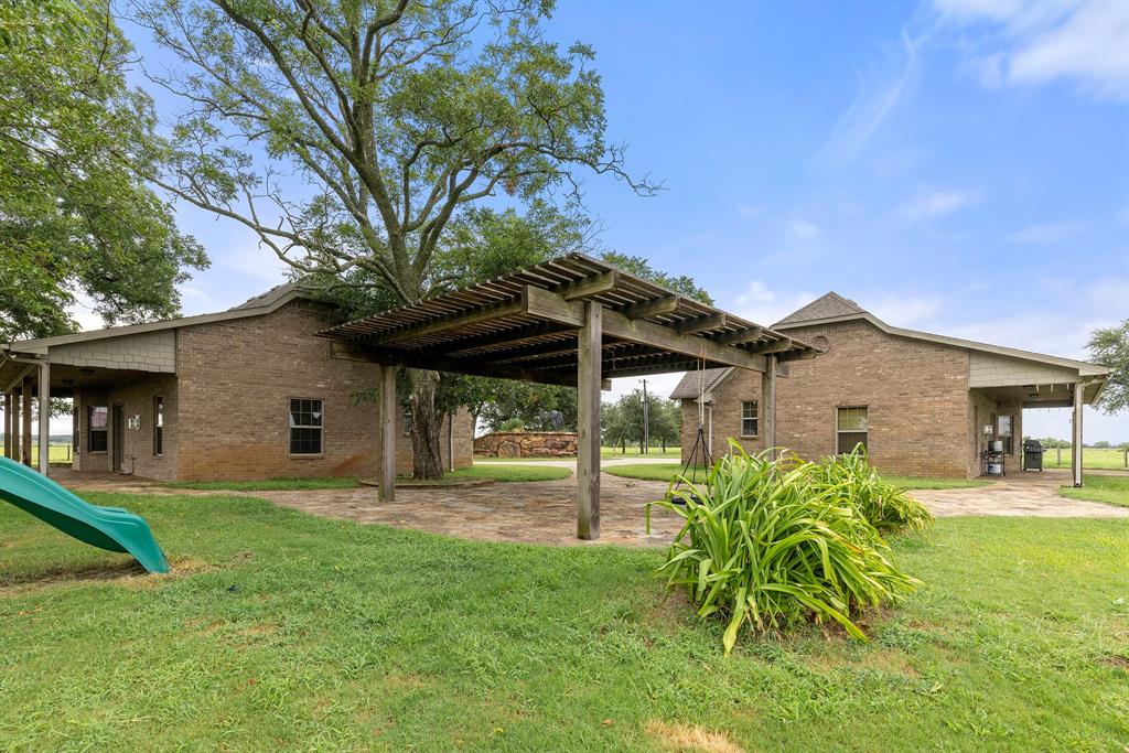 789 Stiles Road, Unit 789 Whitesboro, TX 76273 - Photo 6 of 34 View of grassy yard featuring a patio area, a pergola, and a playground