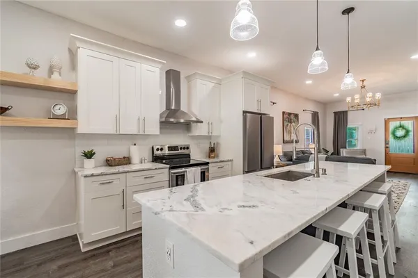 a kitchen with white cabinets and stainless steel appliances