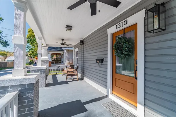 a living room with furniture a dining table and a flat screen tv