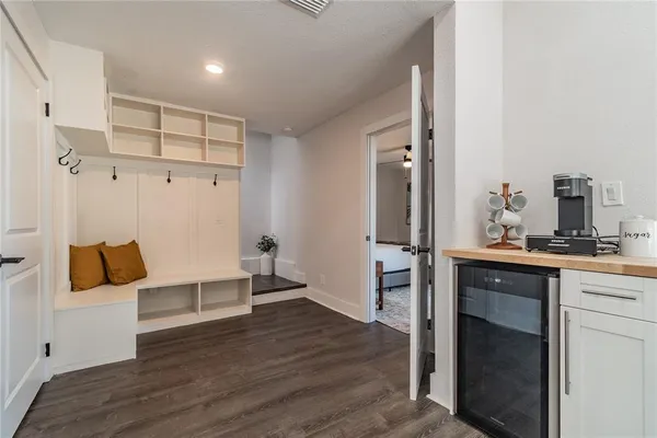 a large bed sitting in a bedroom next to a window