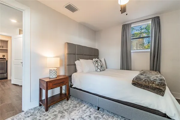 a view of a backyard with wooden fence and a bench