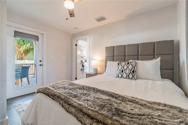 a bathroom with a granite countertop toilet sink and mirror
