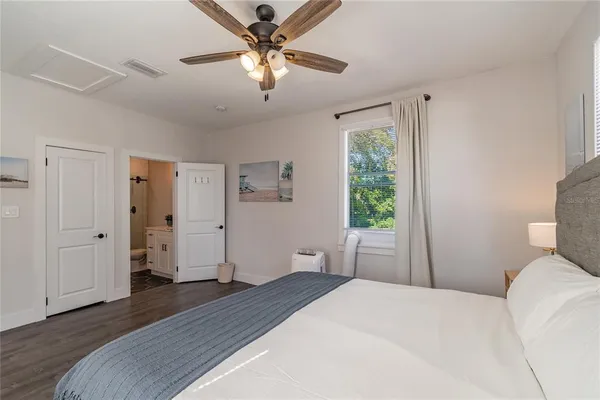 an aerial view of a house with a yard and large trees