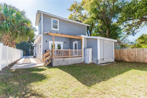 a backyard of a house with a table and chair