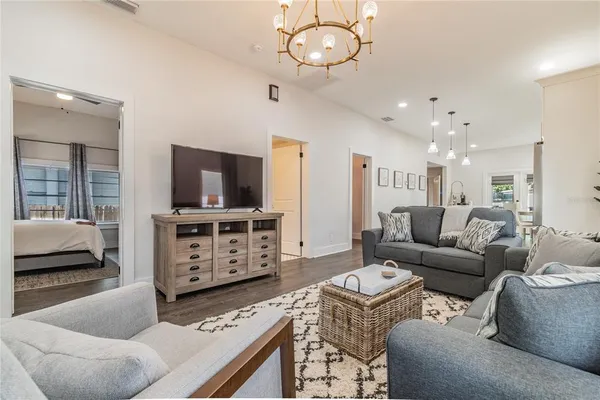 a living room with furniture and a chandelier