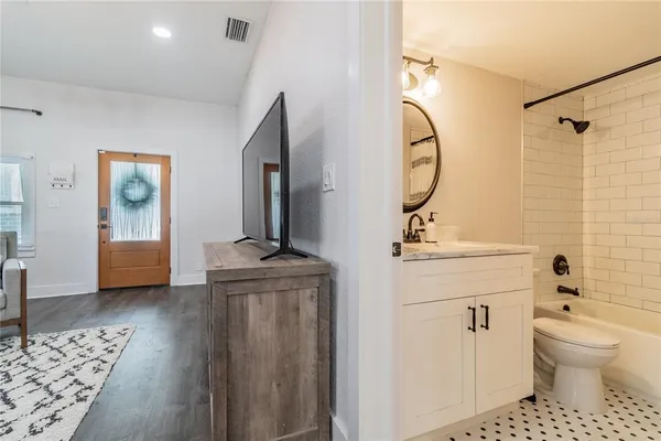 a bathroom with a granite countertop sink toilet and shower