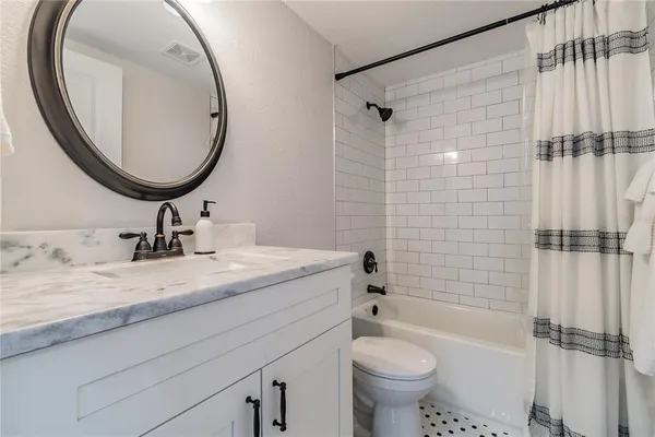 a bathroom with a toilet a sink and a mirror