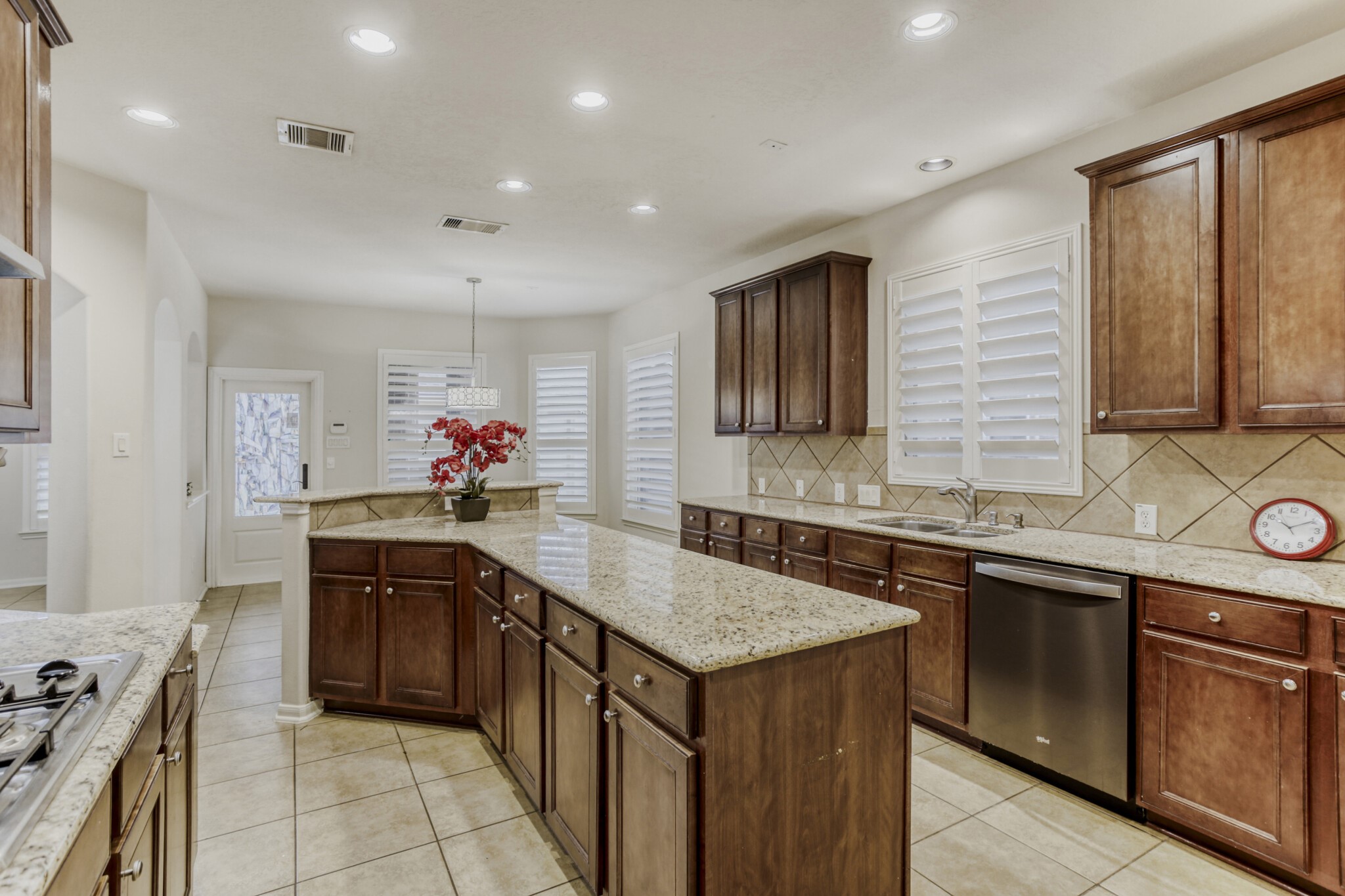 19303 Valiant Woods Drive Spring, TX 77379 - Photo 11 of 27 This kitchen boasts elegant granite countertops, rich wooden cabinetry, and modern stainless steel appliances, offering a perfect blend of style and functionality for your culinary adventures.