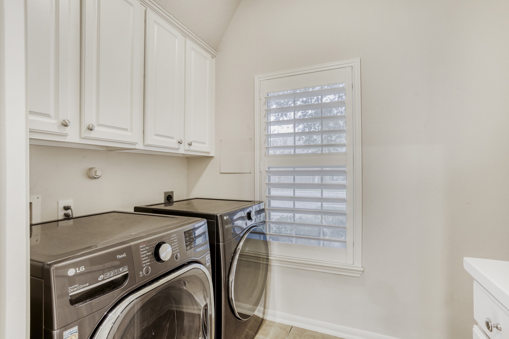 19303 Valiant Woods Drive Spring, TX 77379 - Photo 22 of 27 This bright utility room features modern appliances, ample storage, and a stylish window, making laundry a breeze.