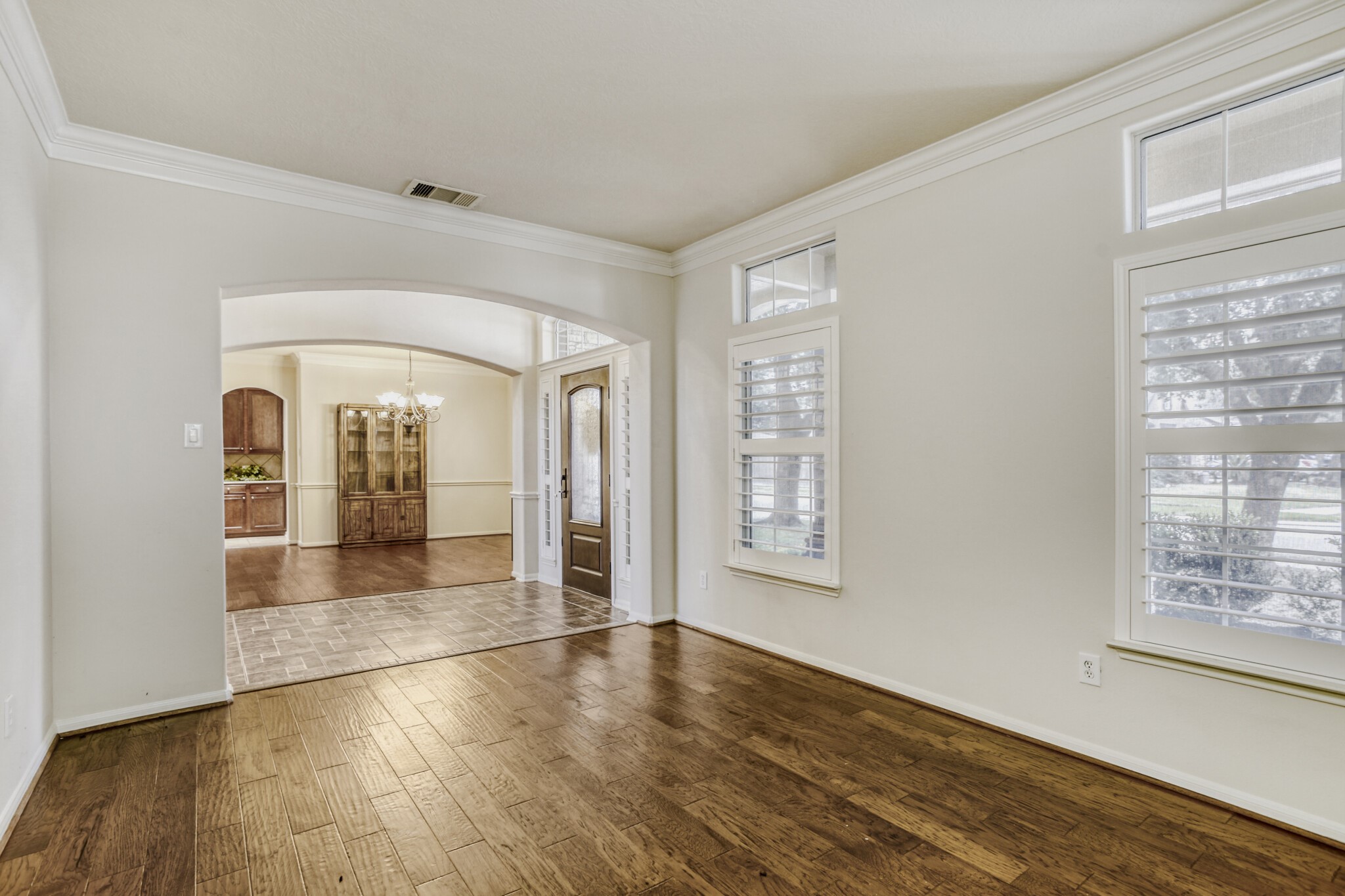 19303 Valiant Woods Drive Spring, TX 77379 - Photo 6 of 27 This bright and inviting study features elegant wood flooring, abundant natural light from large windows, and seamlessly connects to a charming dining area, perfect for both work and relaxation.