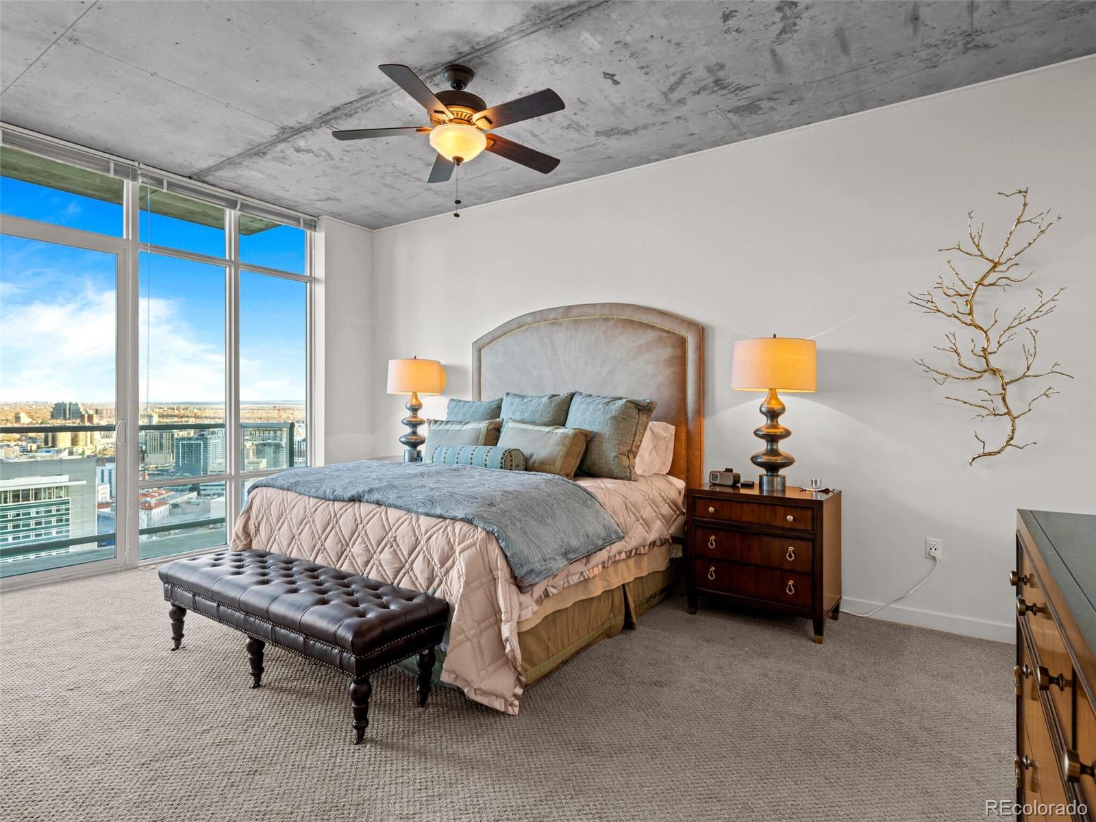 891 14th Street, Unit 3510 Denver, CO 80202 - Photo 17 of 50 a spacious bedroom with a bed painting on wall and a large window