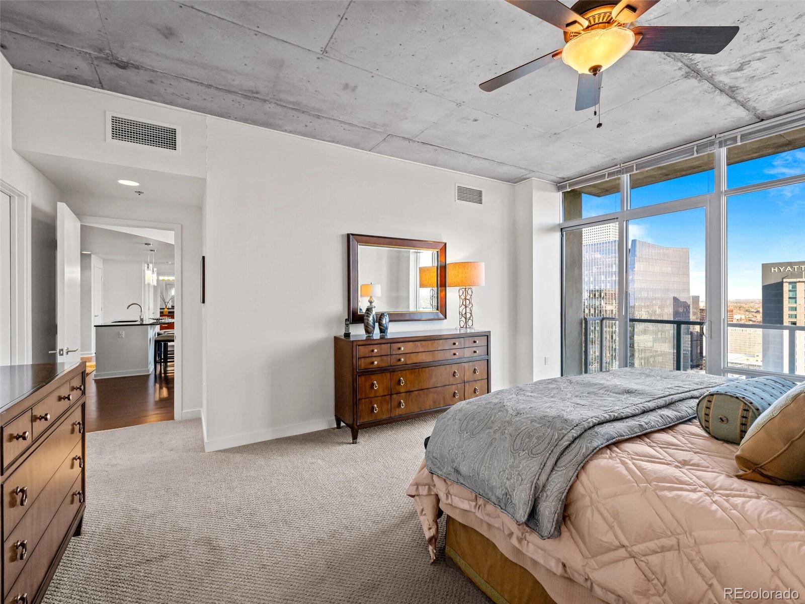 891 14th Street, Unit 3510 Denver, CO 80202 - Photo 19 of 50 a spacious bedroom with a bed and a chandelier