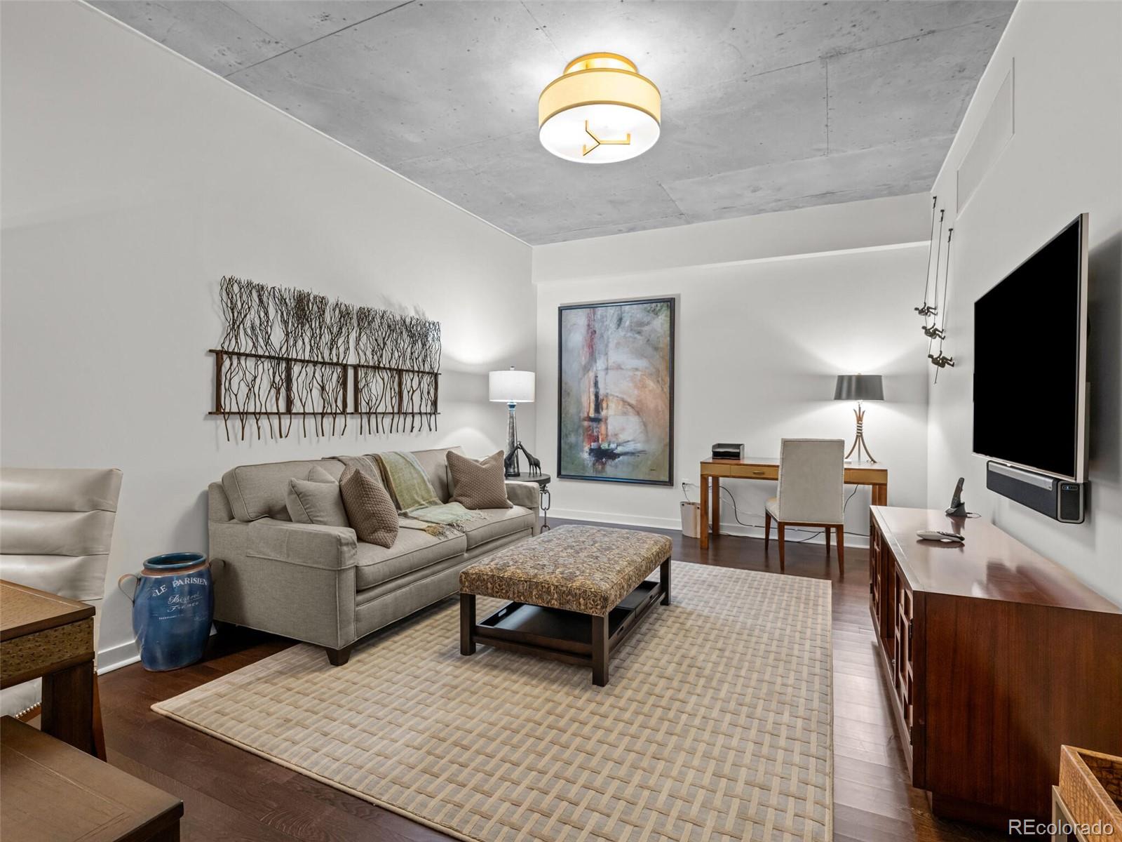 891 14th Street, Unit 3510 Denver, CO 80202 - Photo 26 of 50 a living room with furniture a flat screen tv and a large window