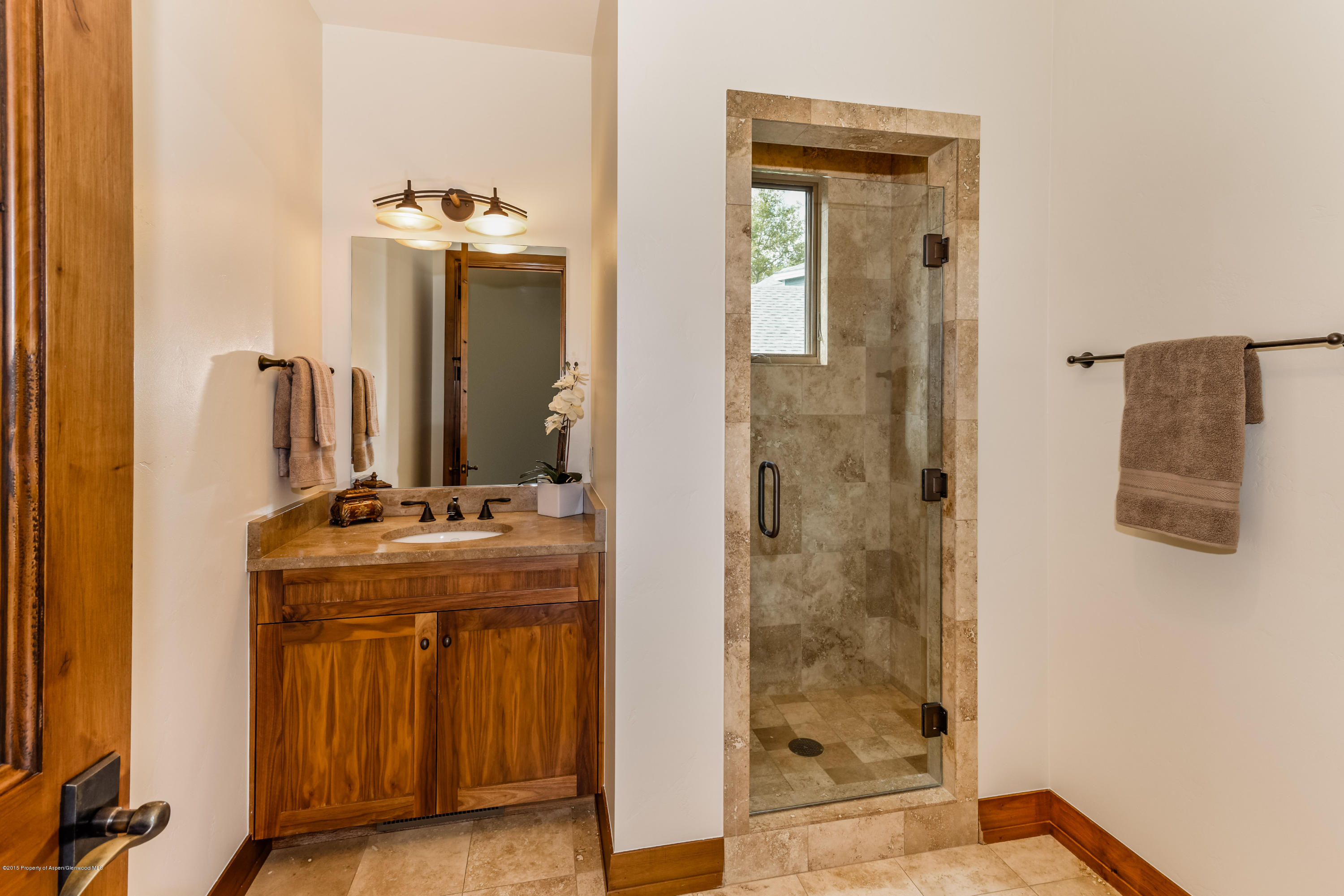360 Riverside Drive Basalt, CO 81621 - Photo 14 of 29 a bathroom with a granite countertop sink a mirror and shower