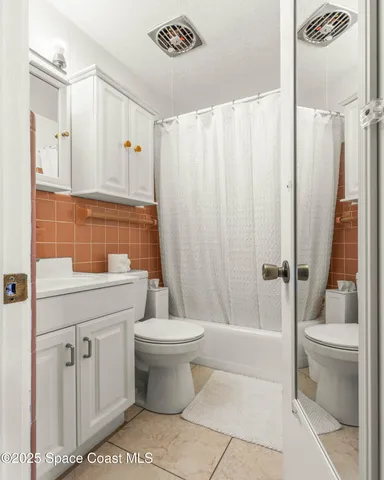 a bedroom with a bed a lamp and a large window