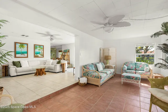 a living room with furniture and a potted plant