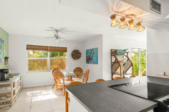 a living room with a table chair and a potted plant