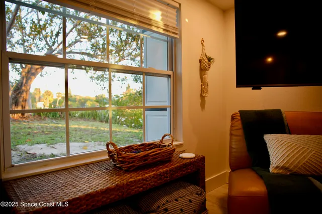 a large bed sitting in a bedroom next to a window