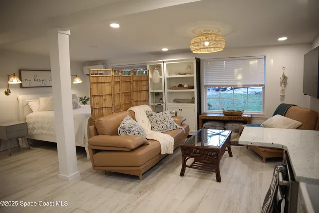 a living room with furniture and a floor to ceiling window