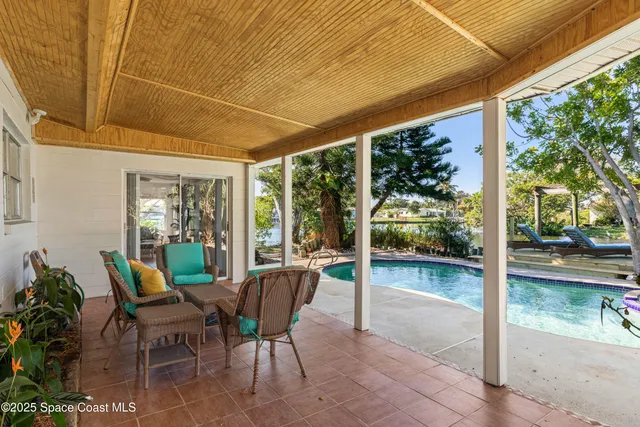 a view of a patio with table and chairs and potted plants