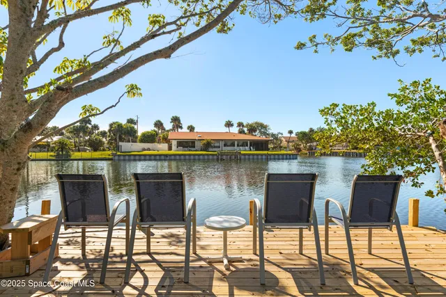 a table and chairs in front of a yard