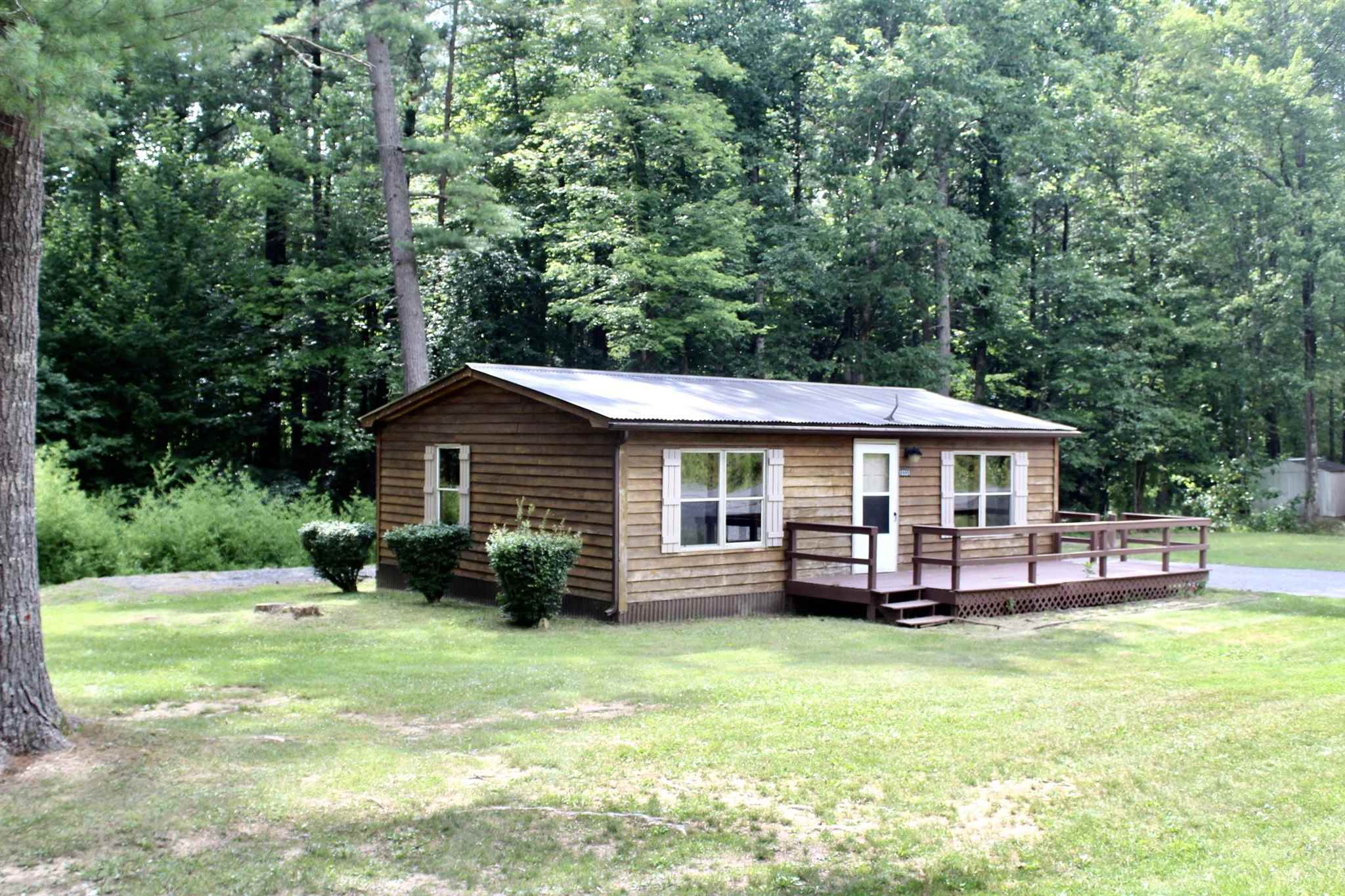 10331 Union Springs Road Dayton, VA 22821 - Photo 3 of 10 a front view of a house with a garden and trees