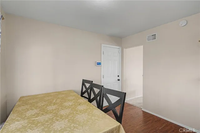 a view of a room with wooden floor and small cabinets