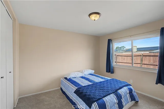 a bedroom with a bed and a window