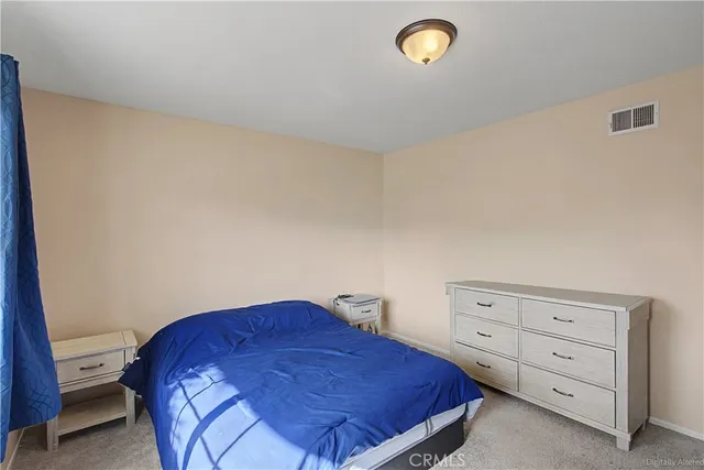 a bedroom with a bed and a lamp