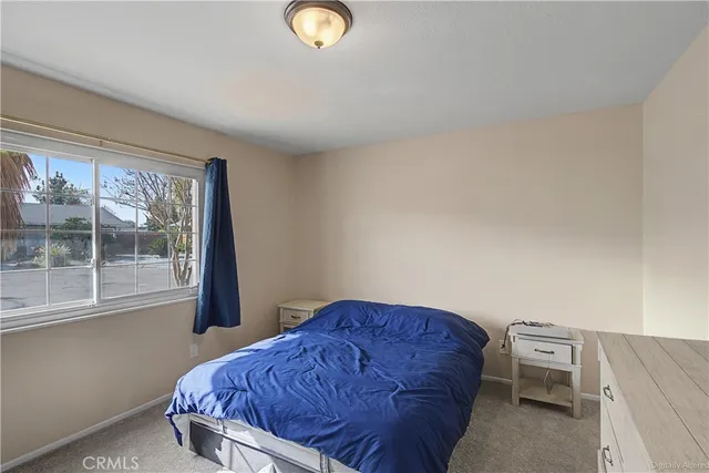 a bedroom with a bed and window