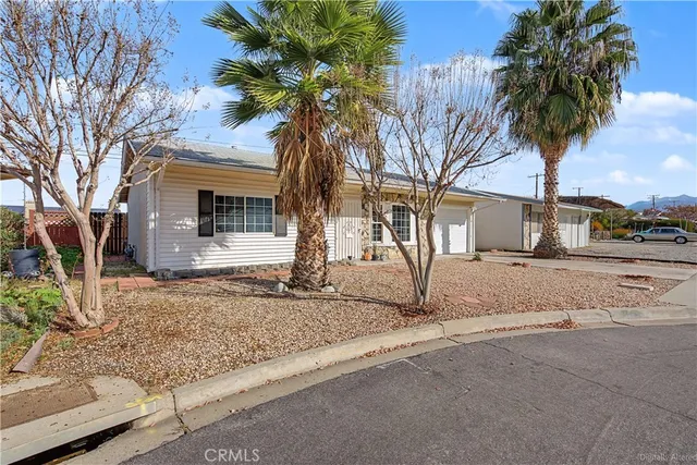 a view of a house with a yard covered with snow