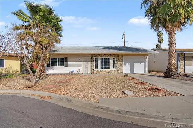 a front view of house with yard and trees