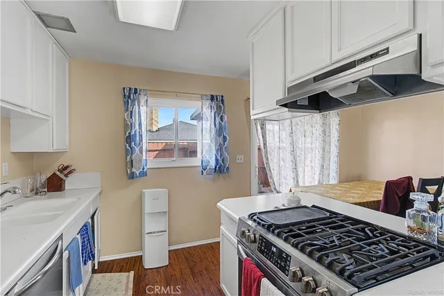 a kitchen with stainless steel appliances granite countertop a stove and a sink