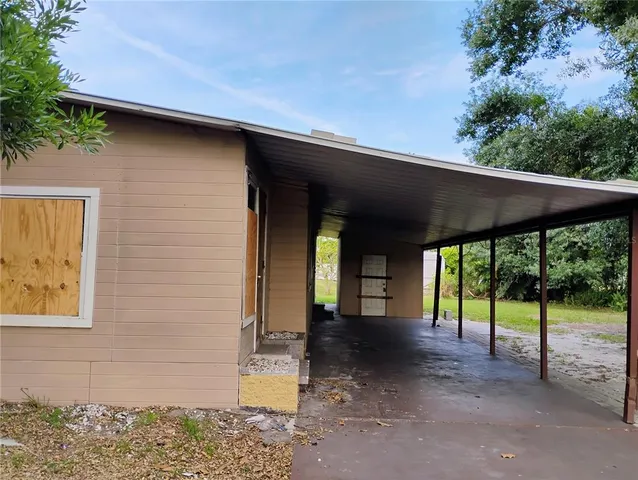 a view of a porch with furniture and floor to ceiling window