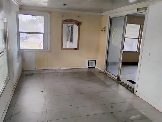 an empty room with windows and closet