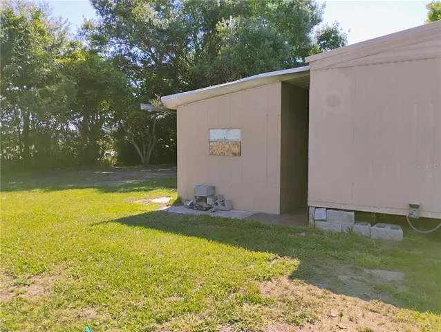 a view of a backyard with swimming pool