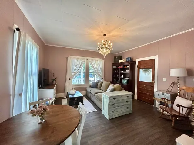 a living room with furniture and a chandelier