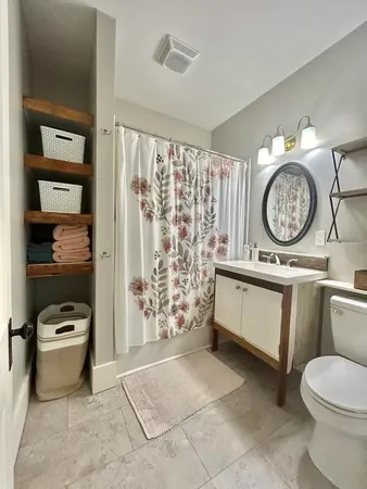 a bathroom with a toilet a sink and a shower