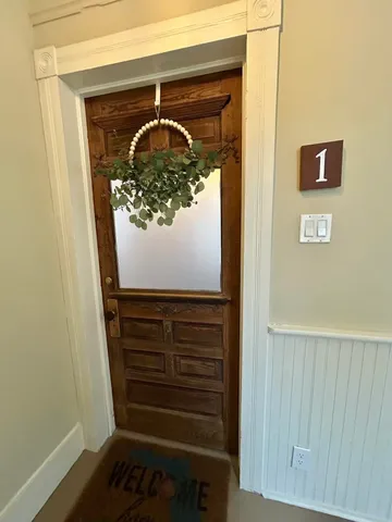 a view of entryway and hall with wooden floor