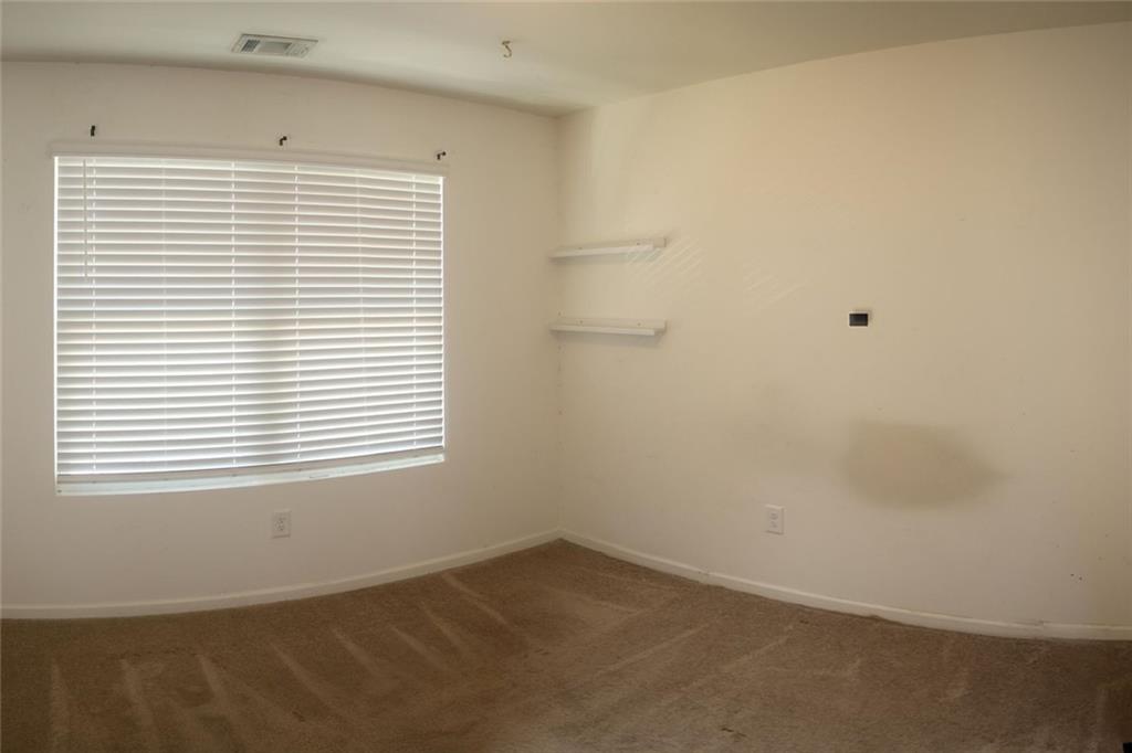 1625 Honeysuckle Path Conyers, GA 30012 - Photo 13 of 17 a view of an empty room with a window