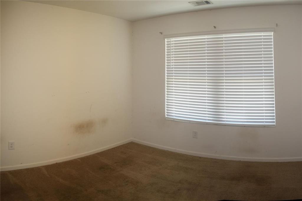 1625 Honeysuckle Path Conyers, GA 30012 - Photo 14 of 17 an empty room with a window