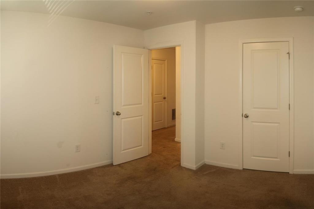 1625 Honeysuckle Path Conyers, GA 30012 - Photo 15 of 17 an empty room with closet area